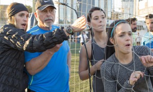 Neil Lumsden and Kristin Lumsden and Dana  Haywoard and Amanda Johnston watch as Nic  struggles with the Soccer challenge on The Amazing Race Canada 3 episode 3